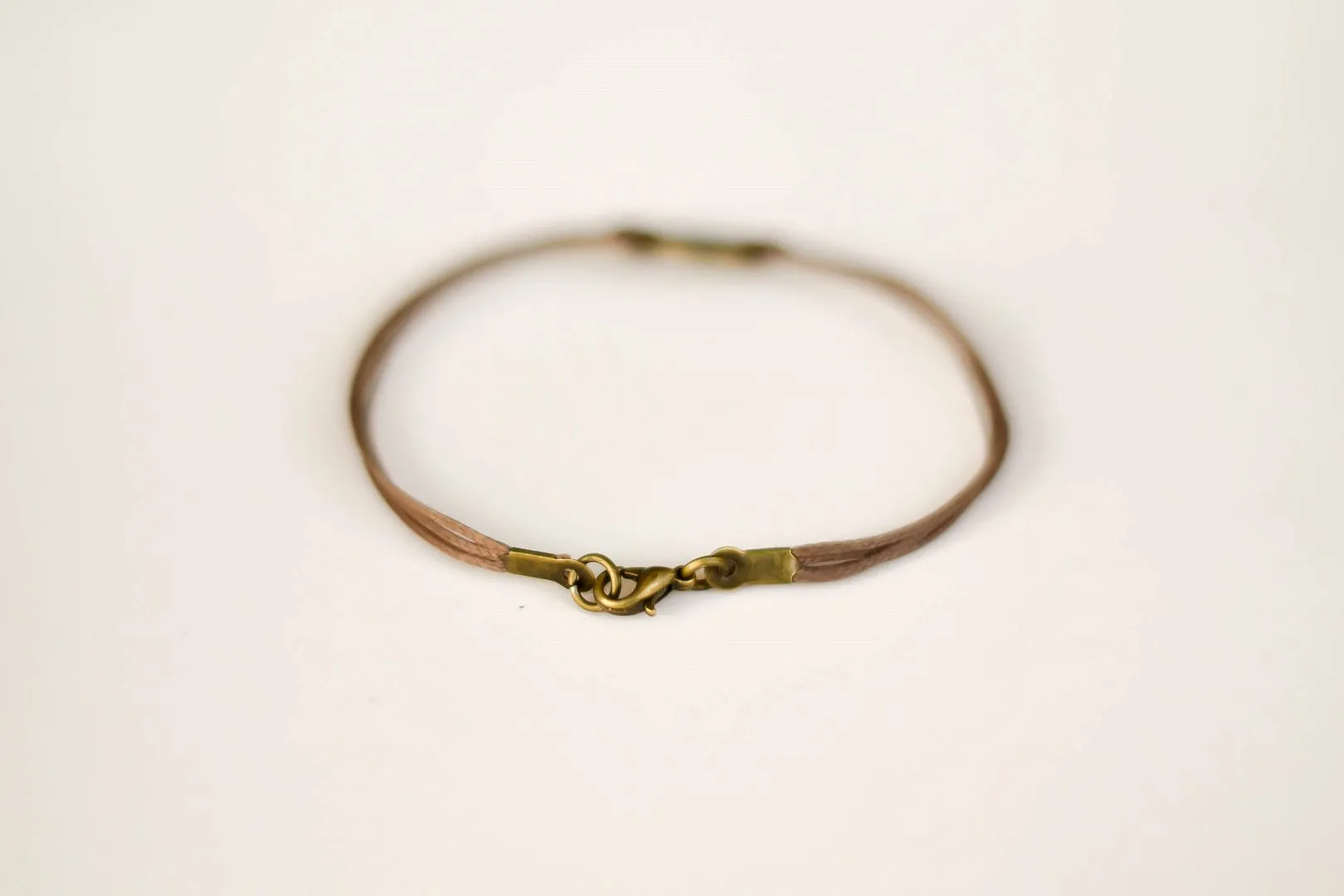 Bronze circle Believe bracelet for men, brown cord, Karma bracelet, fathers gift for him